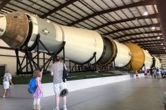 Visitors show the scale of the rocket